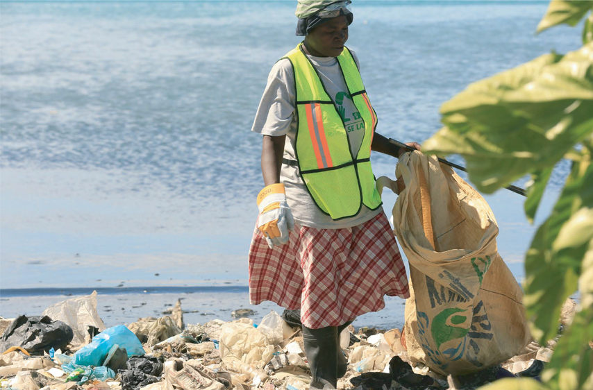 weDo World Oceans Day Image of plastic bottle and beach clean up Plastic Bank and weDo partnership